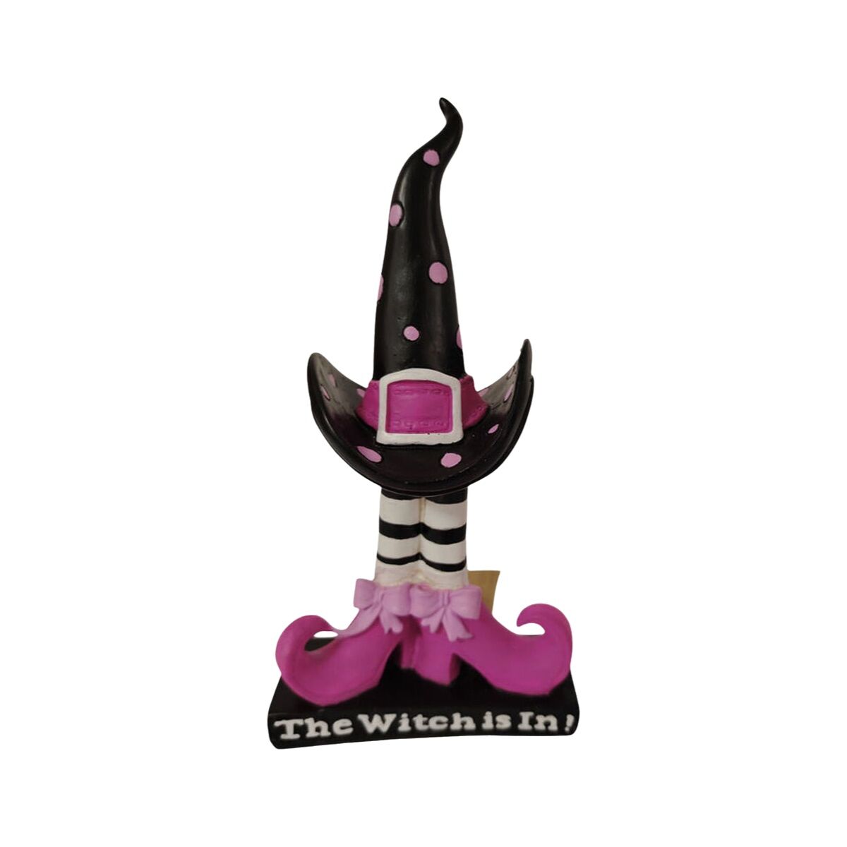 En dekorativ häxbenfigur med hatt och texten 'The Witch is In!'