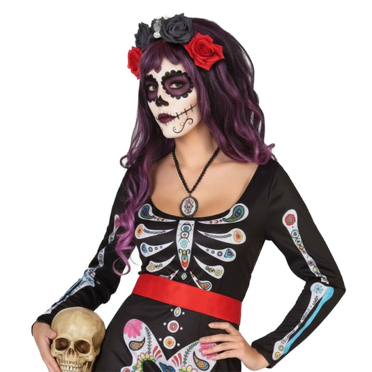 En närbild på en kvinna som bär den svarta överdelen av skelettklänningen, som visar det detaljerade och färgglada trycket.