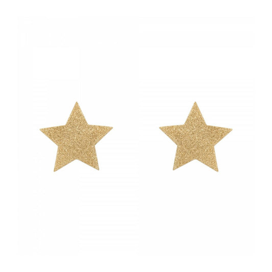 Två guldglittriga självhäftande bröstvårtsskydd formade som stjärnor mot en vit bakgrund.