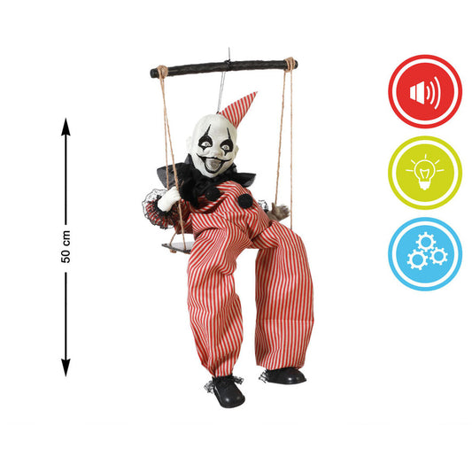 Den 50 cm höga gungande clownen visas bredvid ikoner som symboliserar dess funktioner för ljud, ljus och rörelse.