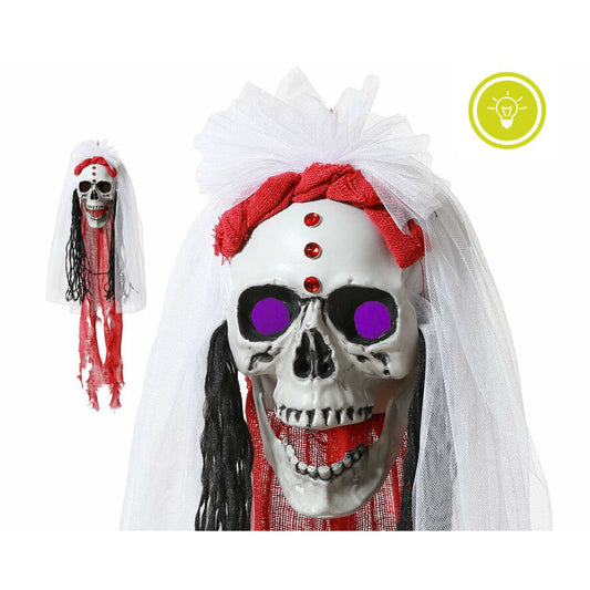 En bild som visar både hela den hängande dekorationen och en närbild där de lila ögonen lyser.