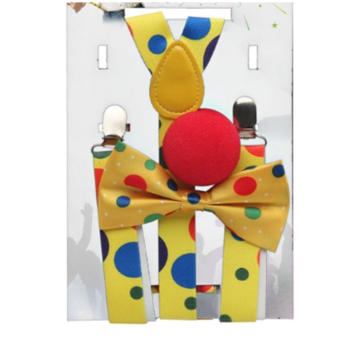 Ett komplett clown-kit i sin förpackning, innehållande gula, prickiga hängslen, en matchande fluga och en röd clownnäsa.