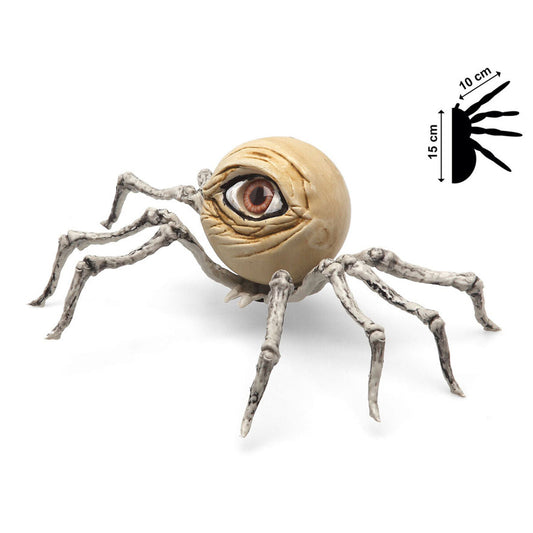 En makaber Halloween-dekoration i form av en spindel med en stor, realistisk människoliknande ögonkula som kropp och ben som ser ut som bleka skelettdelar.