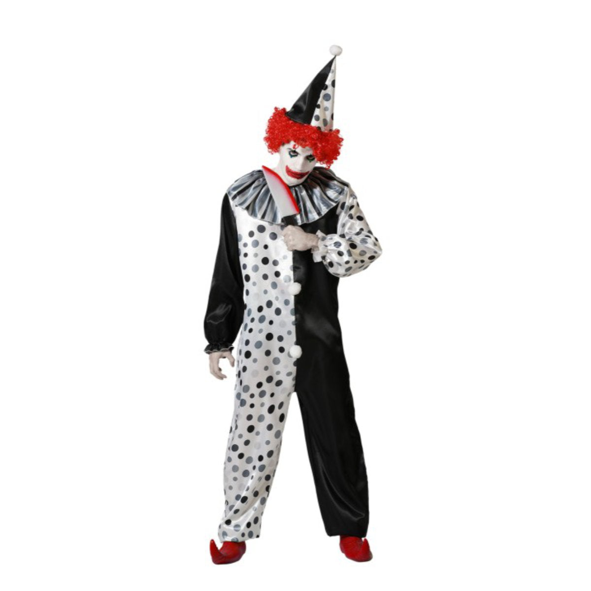 En man, poserar i svartvita, prickiga mördarclown-dräkt med röd peruk och leksakskniv.