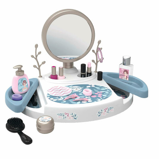 Ett vitt barnsminkbord med en rund spegel, innehållandes diverse leksaks-makeup som nagellack, läppstift, en parfymflaska, en rosa tvålpump, en svart borste och små behållare.