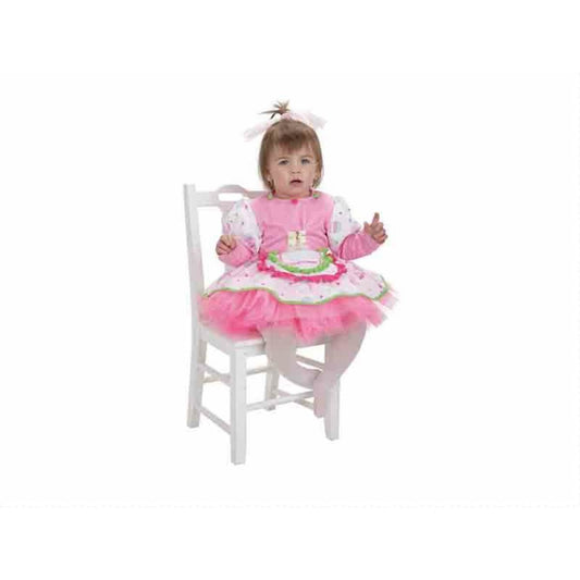 En liten bebis sitter på en vit stol klädd i en rosa och vit Cupcake-maskeraddräkt med tyllkjol.