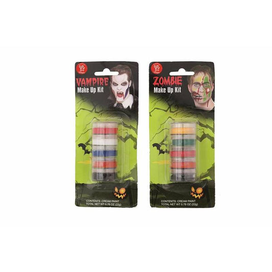 Två förpackningar med barnsminkkit för maskerad, ett med texten 'Vampire Make Up Kit' och ett med 'Zombie Make Up Kit', båda innehållande små burkar med färgad krämbaserad sminkfärg.