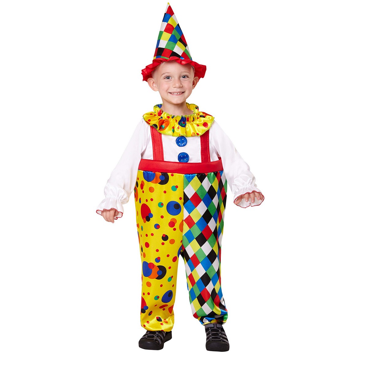 Ett glatt litet barn i en färgglad clowndräkt som består av en gul/flerfärgad jumpsuit med prickar och romber, vit långärmad skjorta, röd volang vid halsen och en matchande konformad clownhatt.