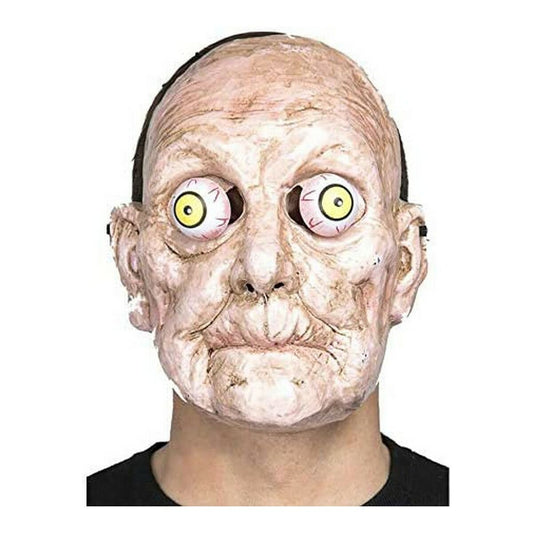 Närbild på en skräckinjagande Halloweenmask som föreställer ett åldrat ansikte med stora, gula, utspärrade ögon.