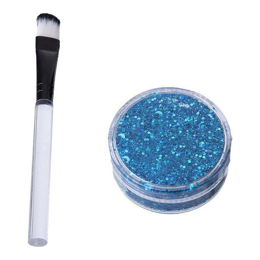 En behållare med intensivt blått glitter bredvid en liten applikationsborste med svart topp och genomskinligt handtag.