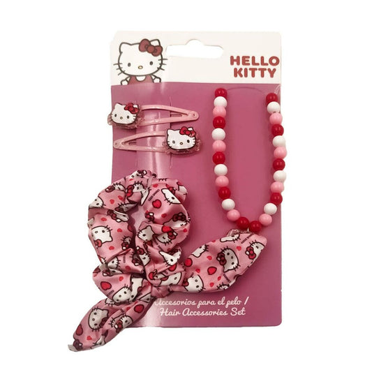 Ett rosa förpackat set med fyra Hello Kitty-inspirerade håraccessoarer, inklusive två hårklämmor, en scrunchie och ett pärlhalsband i rött och vitt.