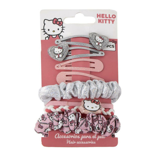 Ett förpackat set med Hello Kitty håraccessoarer som inkluderar glittriga hårklämmor i silver och rosa, samt olika hårsnoddar med glitter och mönster i rosa och vitt.