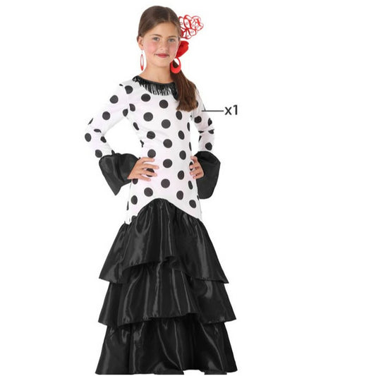 Ett barn i en svart och vit prickig Flamenco-maskeraddräkt med volangkjol och svarta detaljer på ärmar och krage.