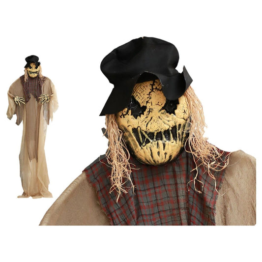 En höjd skräckinjagande Halloween-dekoration föreställande en fågelskrämma med gult, spräckt ansikte, svarta ögonhålor, stråhår och svart hatt.