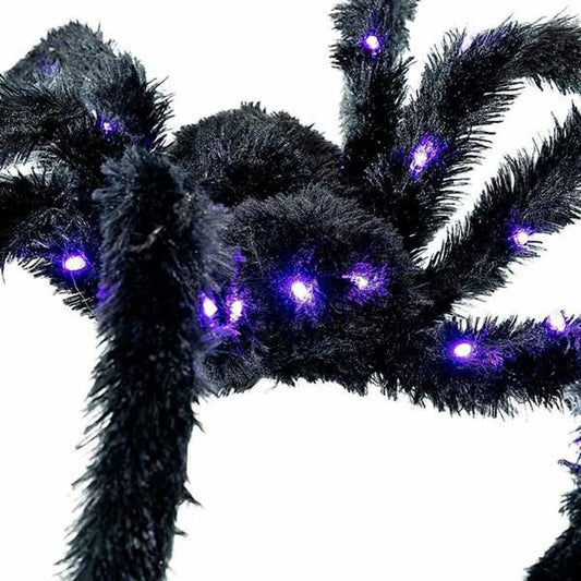 Närbild på den gigantiska, håriga spindeln som visar de intensiva lila LED-lamporna.