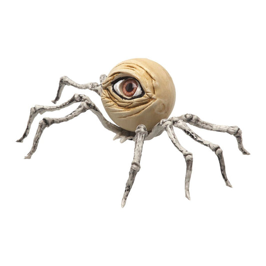 En makaber Halloween-dekoration i form av en spindel med en stor, realistisk människoliknande ögonkula som kropp och ben som ser ut som bleka skelettdelar.