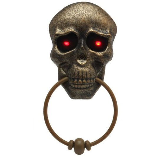 En ondskefull, bronsfärgad dörrkläpp formad som en dödskalle med lysande röda ögon.