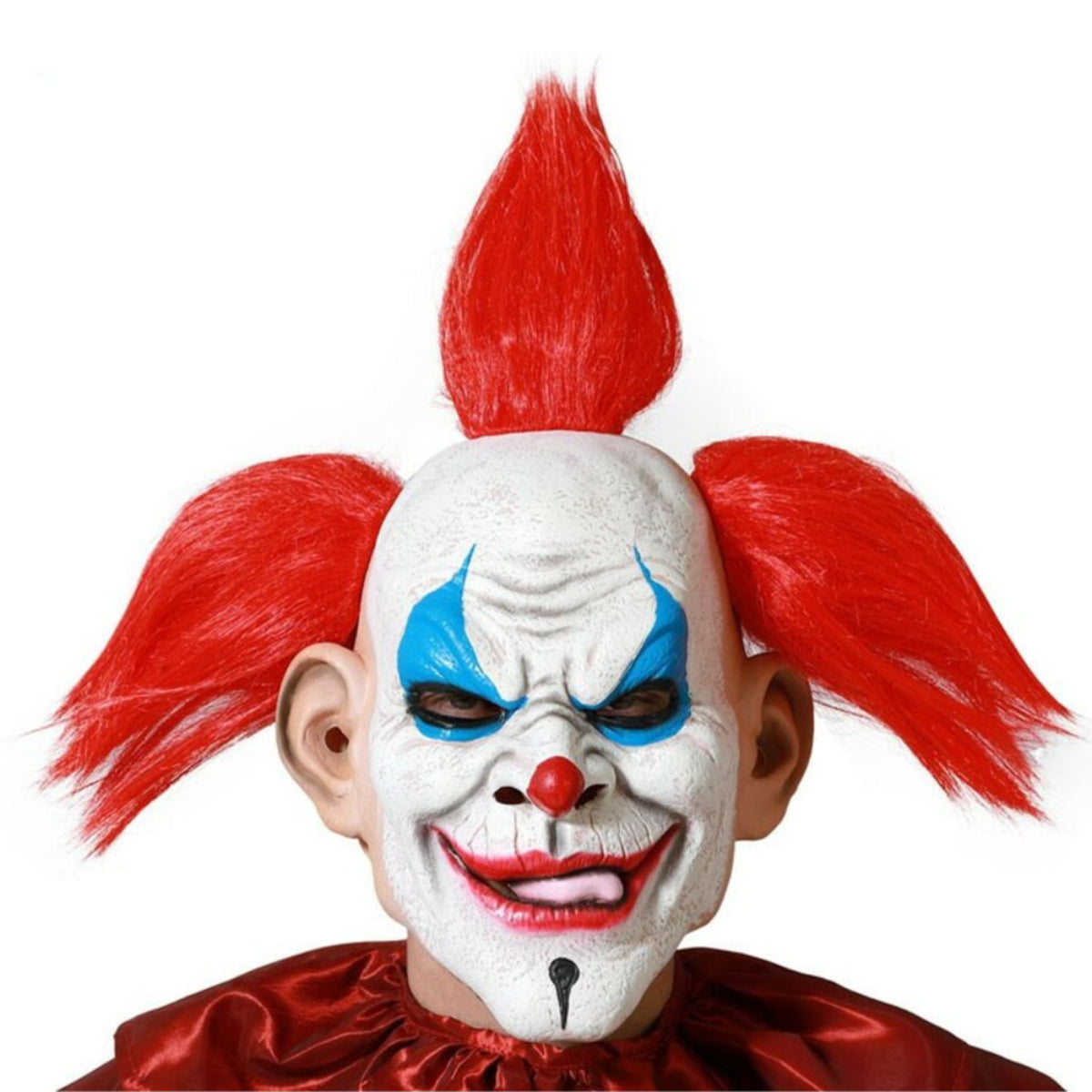 En person bär en Ondskefull Punk-Clown Mask i latex, med ett elakt leende och en röd mohawk-frisyr.
