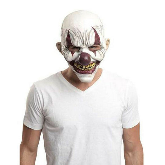 En man bär en skräckinjagande vit clownmask med ett ondskefullt leende och gula tänder.